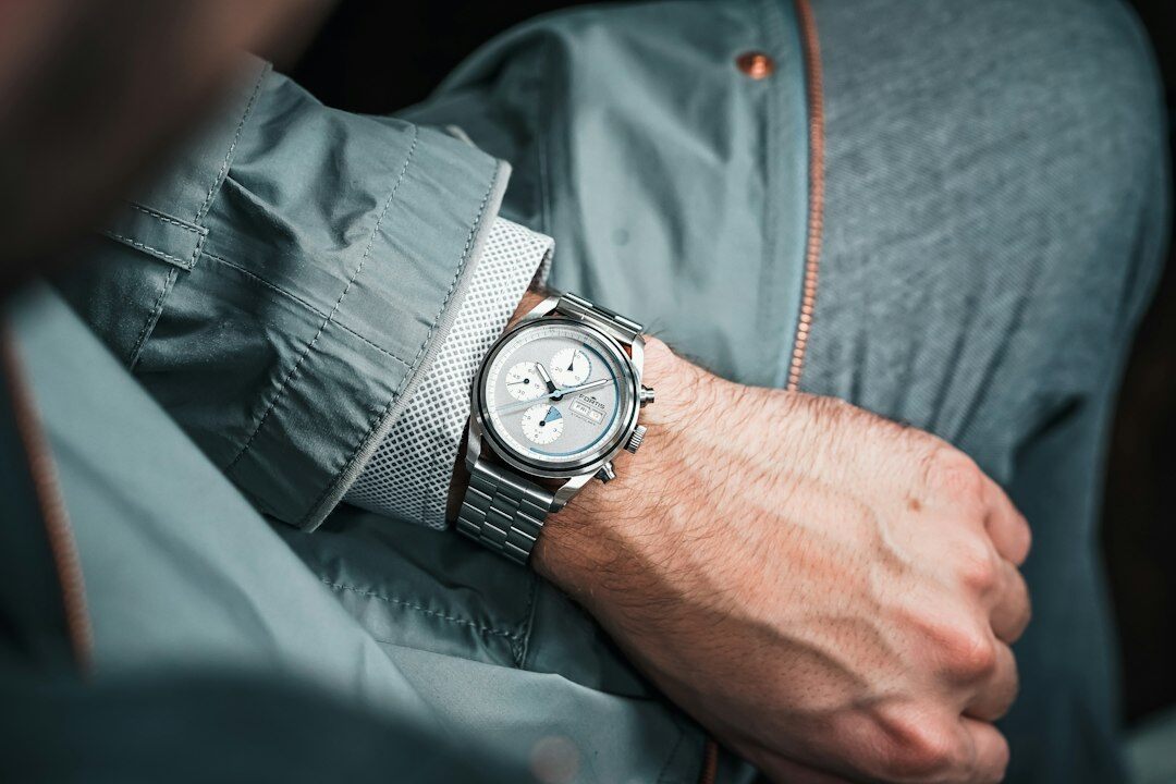 Elegant hands adjusting a luxury chronograph watch