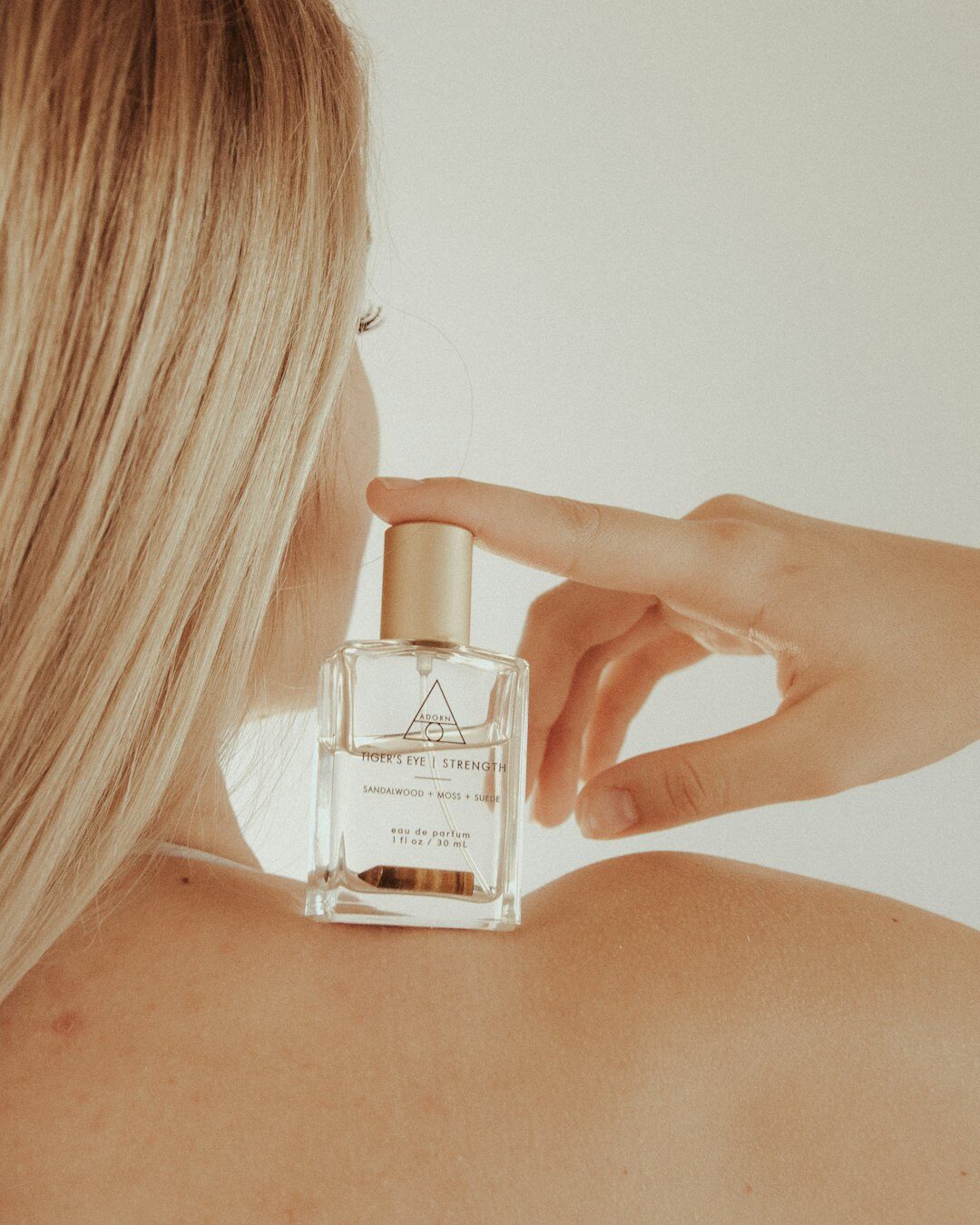 woman applying luxury perfume